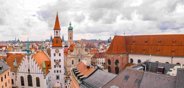 old-town-hall-surrounded-by-buildings-cloudy-sky-daytime-munich-germany-compressed-compressed