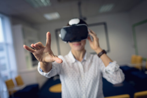 Businesswoman using virtual reality headset in office
